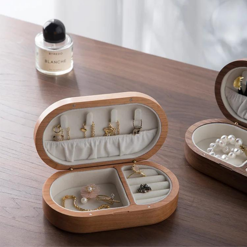 Oval mini wooden jewellery box with a rich walnut finish, featuring soft velvet lining for protection. Ideal for organizing rings and earrings, it combines elegance and functionality 2