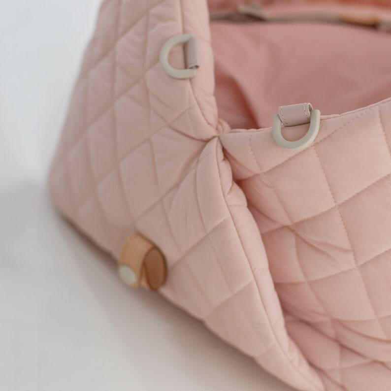 Beige quilted fabric pet carrier designed for versatility as a car seat and carrier. Measures 17.3 x 13.4 x 17 6