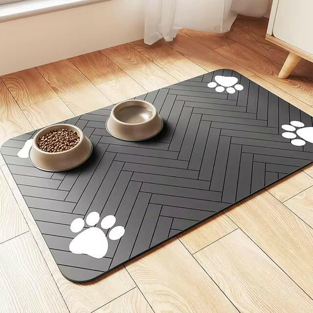 Charcoal grey waterproof rubber pet feeding mat featuring paw-print accents. Non-slip design for stability and easy to clean. Available in small and large sizes, 7