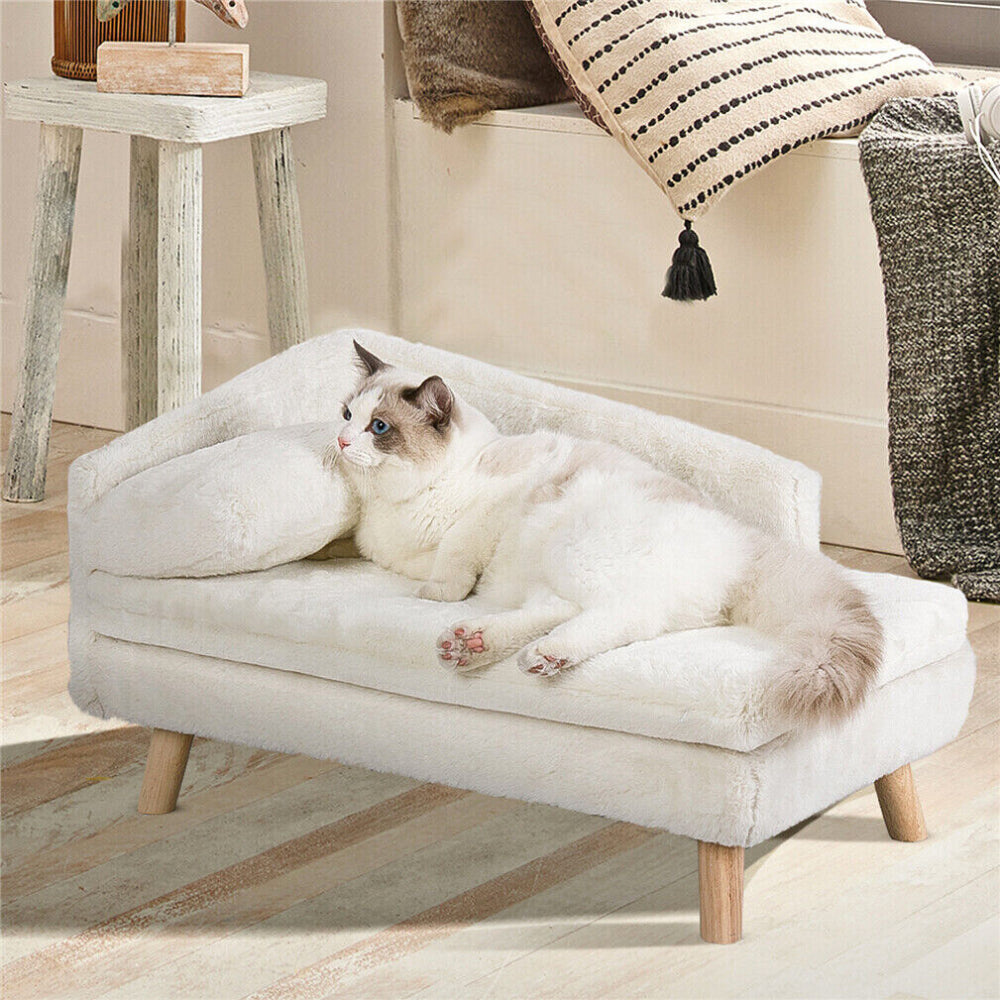 Cozy beige pet bed made from plush linter fabric, featuring stylish wooden legs. Available in two sizes, 27.6 x 15. 2
