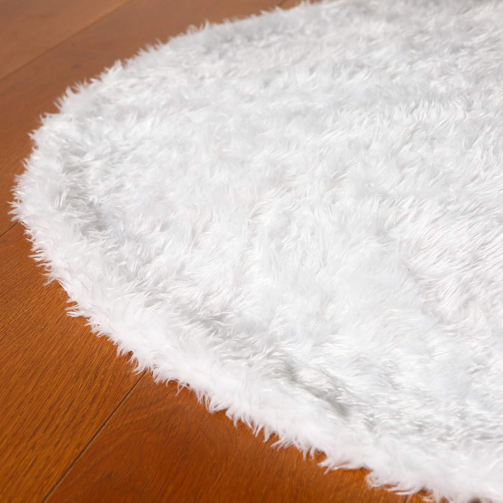 Cozy 30-inch plush faux fur Christmas tree skirt in soft white with a luxurious texture, perfect for adding warmth and elegance to your holiday decor. 1