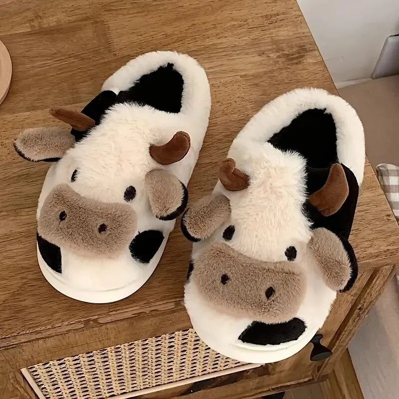 Cozy unisex slippers featuring a trendy cow motif, made from soft plush material. These comfortable slippers come in a neutral color palette, perfect for lounging 0