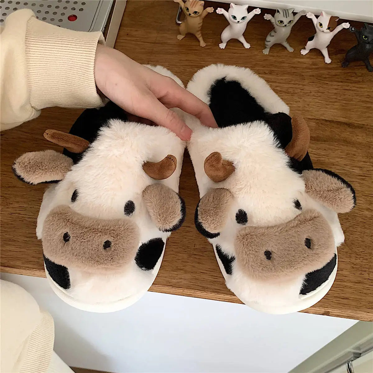 Cozy plush unisex slippers featuring a trendy cow motif, perfect for indoor wear. Made from soft, durable materials in a stylish black and white design 1