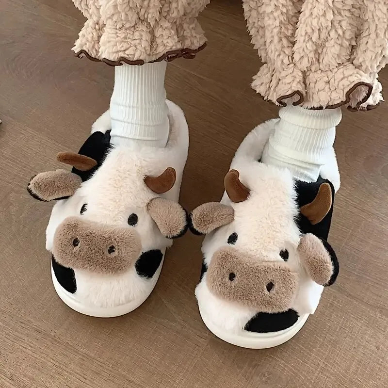 Cozy unisex plush slippers featuring a trendy cow motif, designed for ultimate comfort. Made from soft, high-quality materials in a classic black and white 3