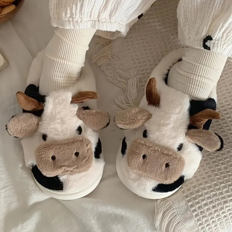 Cozy plush unisex slippers featuring a trendy cow motif, crafted from soft, durable fabric. These comfortable slippers come in a classic white and black color 4