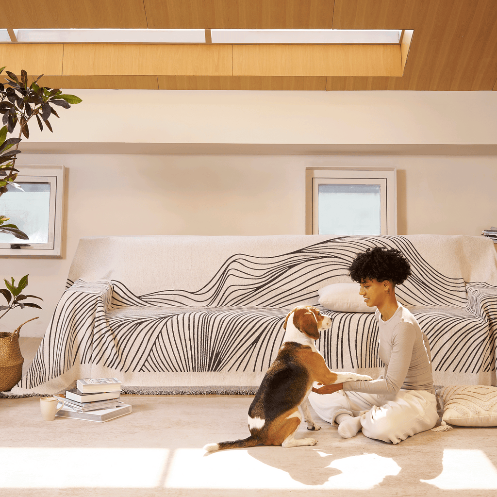 Reversible jacquard sofa cover in soft gray and cream, featuring an intricate woven pattern. Made from durable, pet-friendly fabric, it effortlessly protects 1