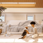 Reversible jacquard sofa cover in soft gray and cream, featuring an intricate woven pattern. Made from durable, pet-friendly fabric, it effortlessly protects 1