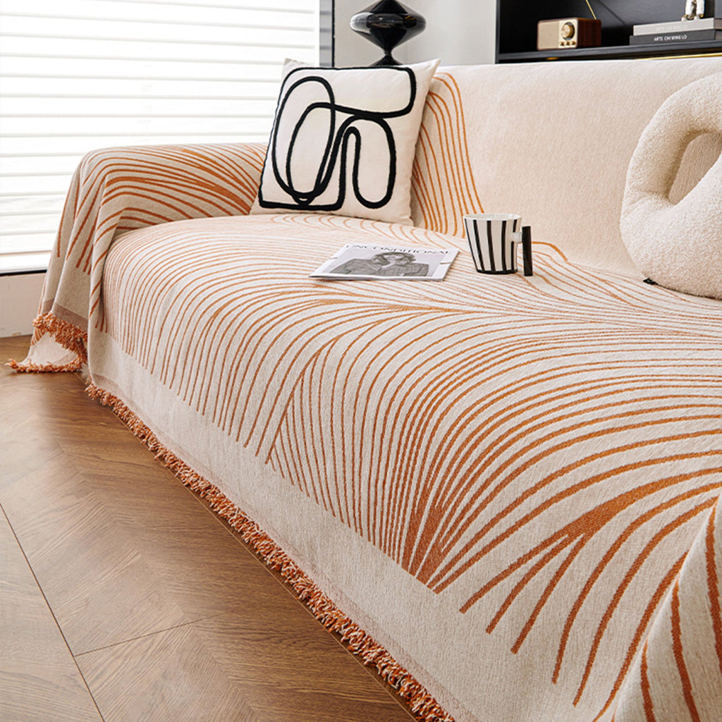 Reversible jacquard sofa cover in soft gray and cream, featuring an intricate woven pattern. Made from durable, pet-friendly fabric, it effortlessly protects 10