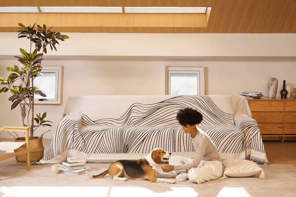 Reversible jacquard sofa cover in soft gray and cream, featuring an intricate woven pattern. Made from durable, pet-friendly fabric, it effortlessly protects 2