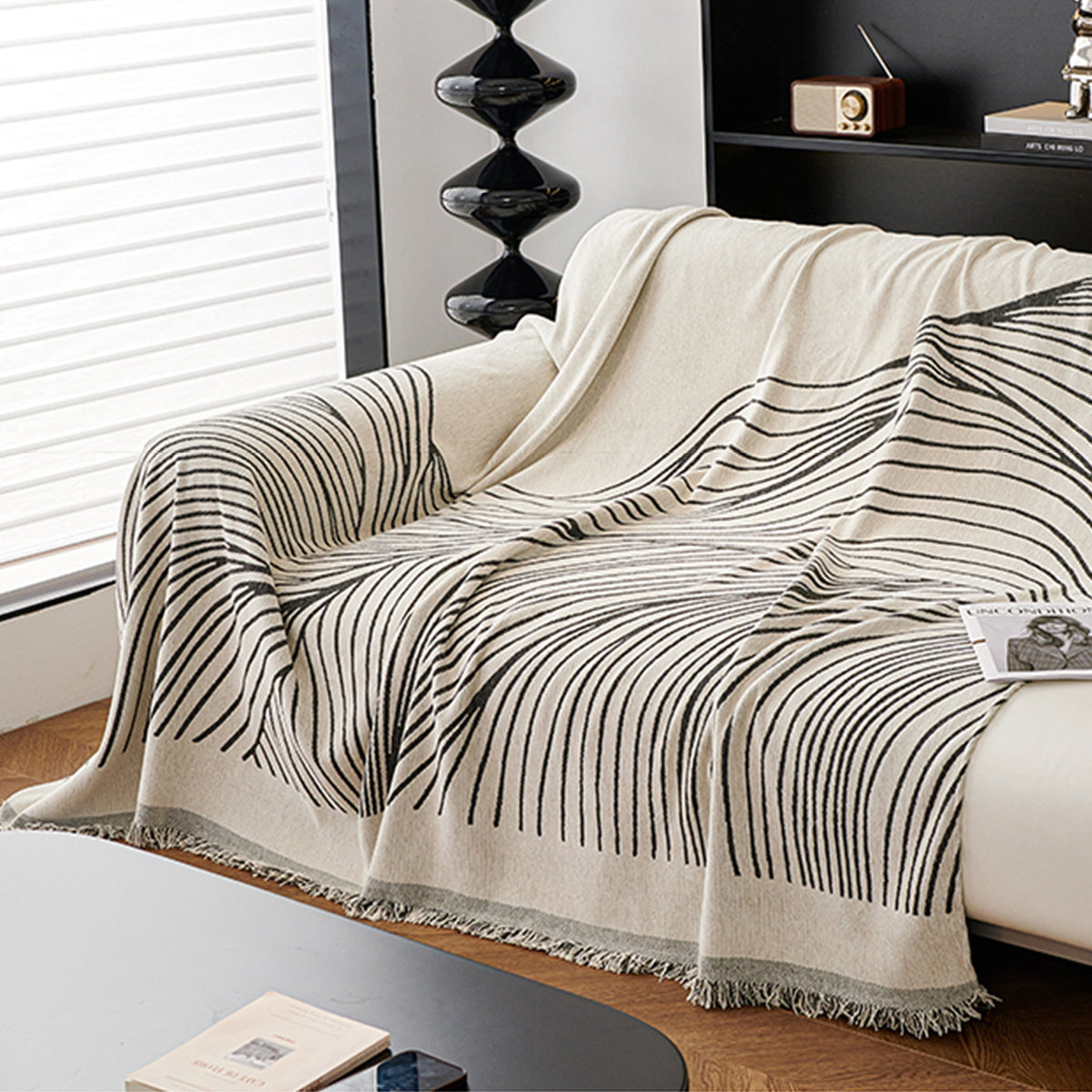 Reversible jacquard sofa cover in soft gray and cream, featuring an intricate woven pattern. Made from durable, pet-friendly fabric, it effortlessly protects 3