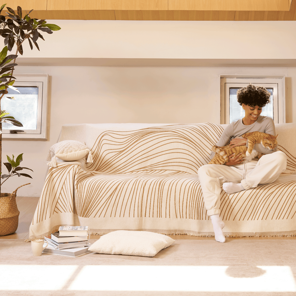 Reversible jacquard sofa cover in soft gray and cream, featuring an intricate woven pattern. Made from durable, pet-friendly fabric, it effortlessly protects 7