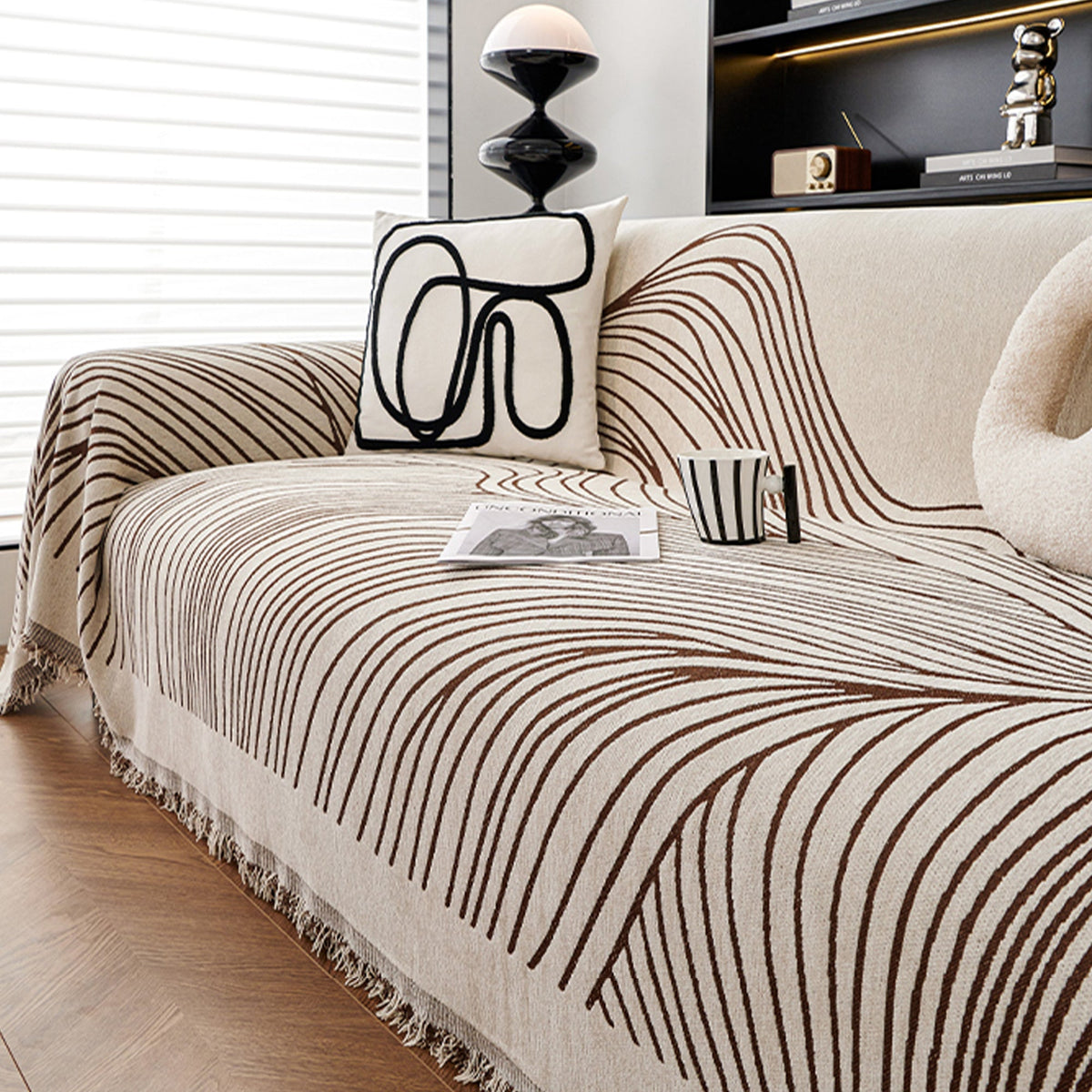 Reversible jacquard sofa cover in soft gray and cream, featuring an intricate woven pattern. Made from durable, pet-friendly fabric, it effortlessly protects 9