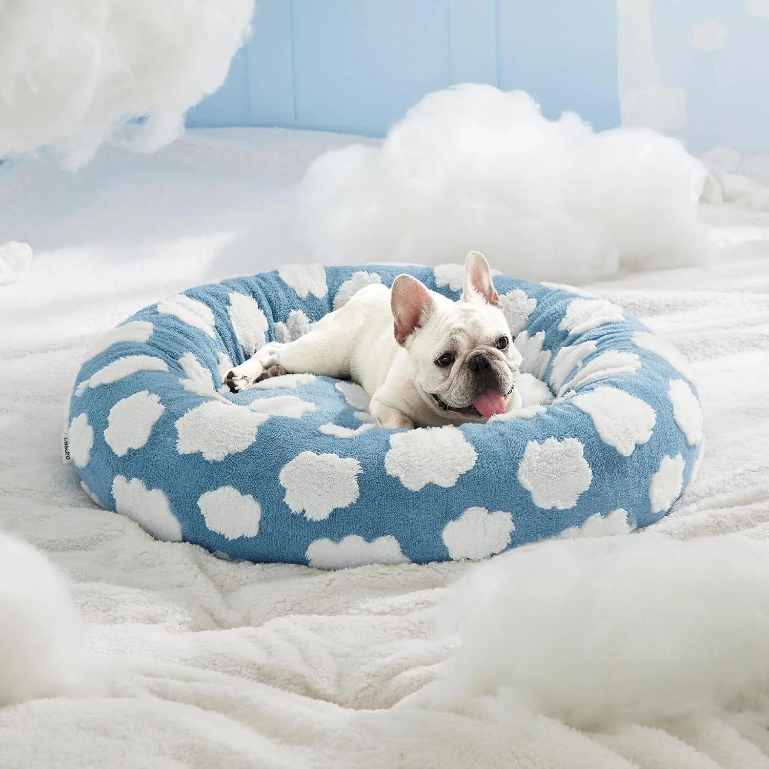 Round soft cozy pet bed for dogs and cats in a versatile gray color. Made from plush fabric, it features a thick cushioned rim for support and 2