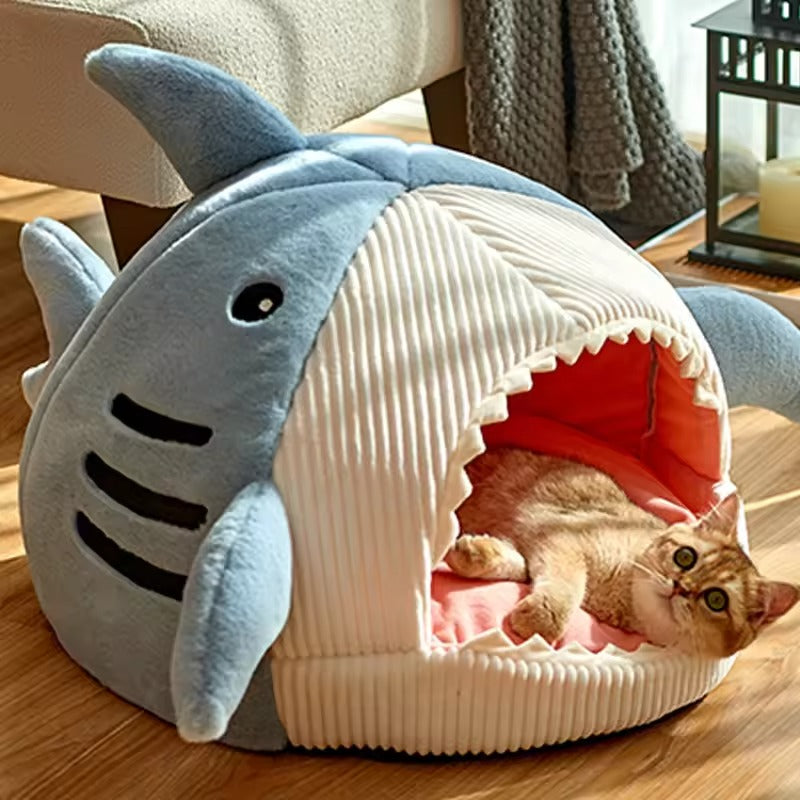 Shark-shaped cat bed made from soft corduroy and plush materials. Cozy pet cave design in a playful shark style, available in three sizes. 0