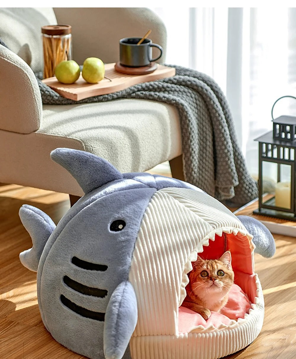Shark-shaped cat bed made of soft corduroy and plush materials, providing a cozy cave for pets. Available in three sizes, featuring a fun 3
