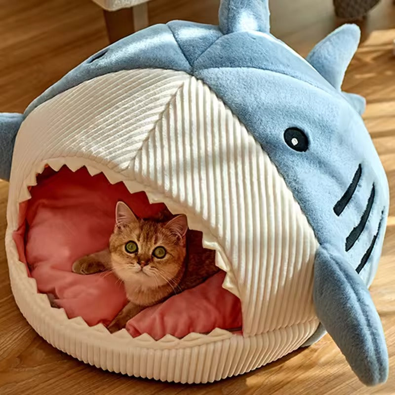 Cozy shark-shaped cat bed made of soft corduroy and plush material. Available in three sizes, it features a fun design perfect for pets to 5