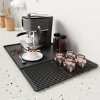 Black silicone coffee bar mat featuring a sleek, modern design. Heat-resistant and waterproof, it provides a durable surface for coffee setups, ensuring easy cleanup and 0