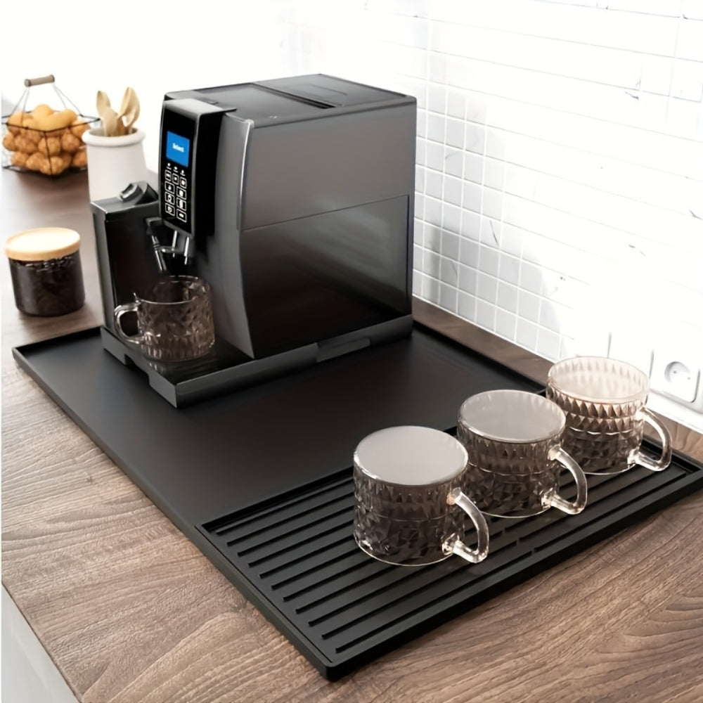 Black silicone coffee bar mat featuring a sleek, modern design. Heat-resistant and waterproof, it provides a durable surface for coffee setups, ensuring easy cleanup and 1