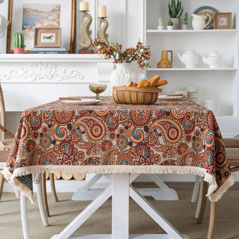 Amber paisley design tablecloth made from a durable microfiber blend, measuring 60 x 84 inches. Ideal for dining and decor, this vibrant table 0