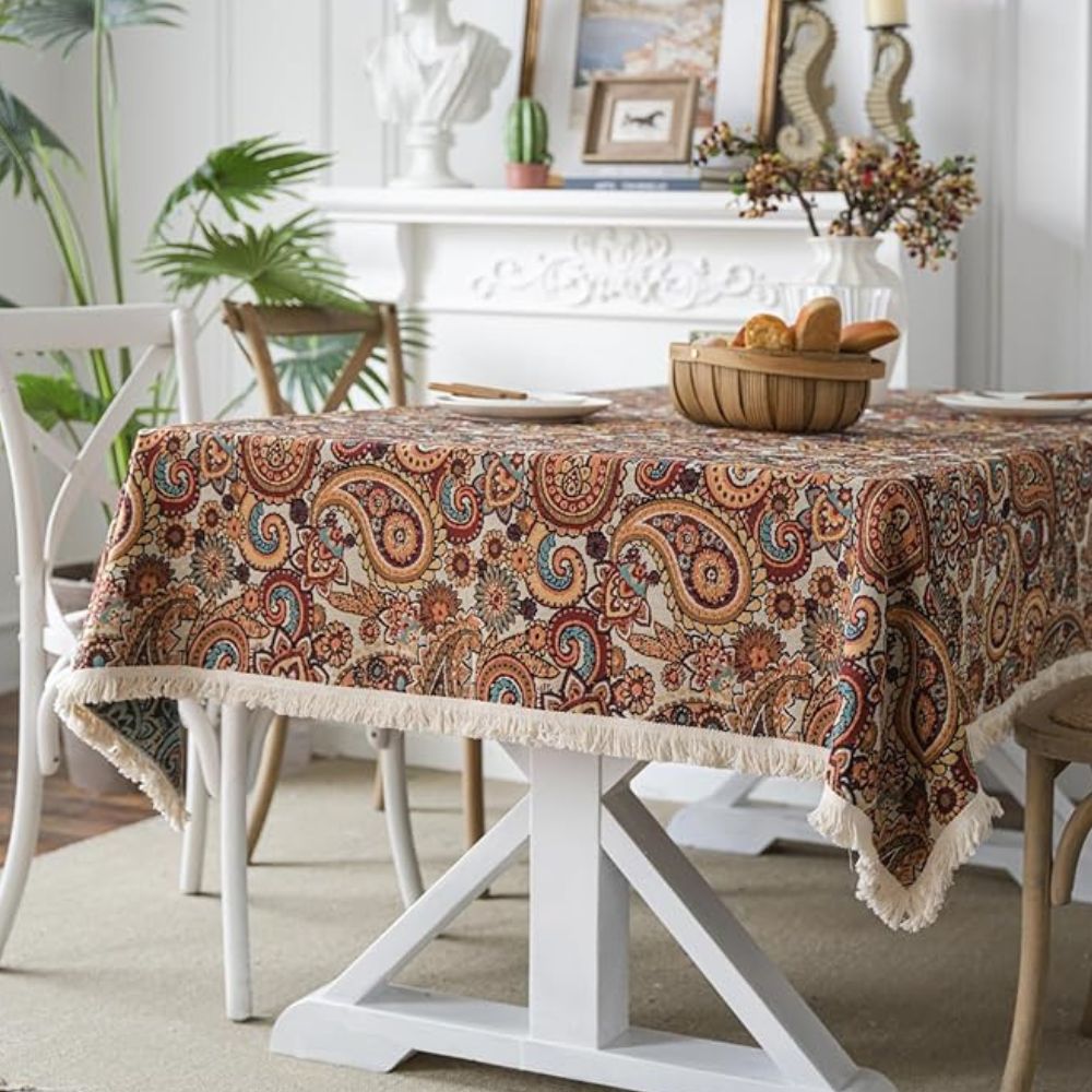 Amber paisley design tablecloth made from a durable microfiber blend, measuring 60 x 84 inches. Ideal for dining and decor, this vibrant table 1