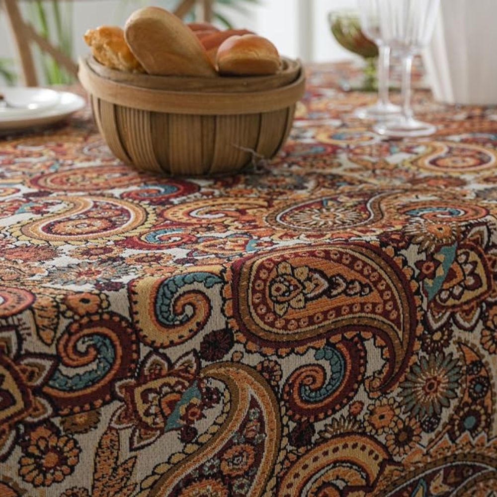 Amber paisley design tablecloth made from a durable microfiber blend, measuring 60 x 84 inches. Ideal for dining and decor, this vibrant table 2