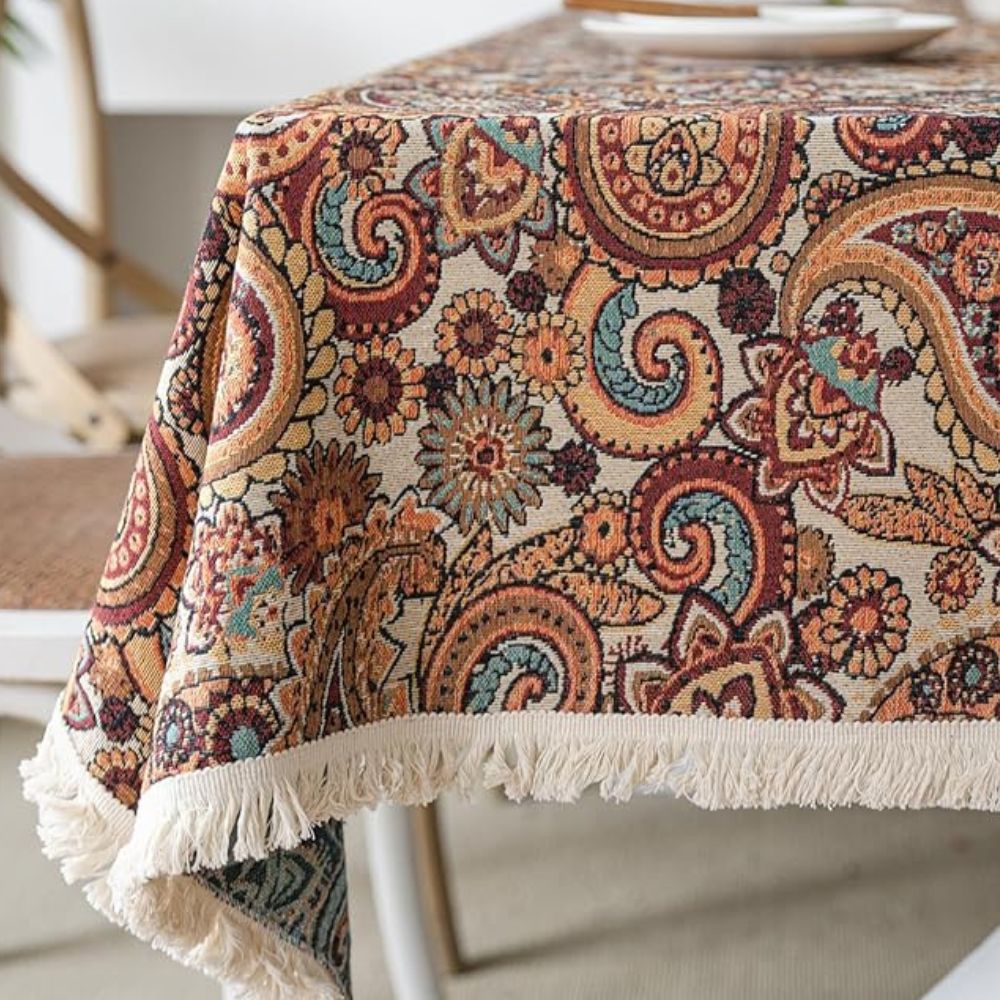 Amber paisley design tablecloth made from a durable microfiber blend, measuring 60 x 84 inches. Ideal for dining and decor, this vibrant table 3
