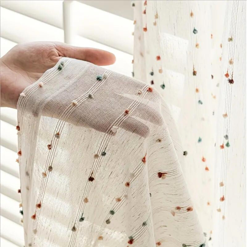 Sheer tulle curtain in a microfiber and cotton blend, featuring vibrant rainbow embroidery. Measures 50 × 84 inches, perfect for adding a colorful 0