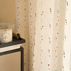 Sheer tulle curtain made from a soft microfiber and cotton blend, featuring vibrant rainbow embroidery. Measures 50 × 84 inches, perfect for adding 3