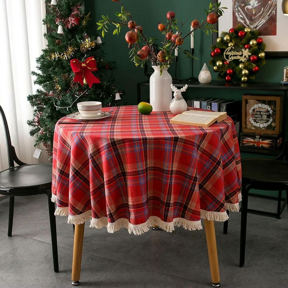 Round tablecloth featuring a vintage holiday plaid pattern in red, green, and white, adorned with decorative tassels. Made from durable fabric, perfect for 3