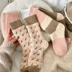 Cozy mid-tube warm terry socks for women in assorted colors. Each pack includes four pairs featuring a soft, plush texture for maximum comfort. 2