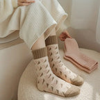Set of 4 cozy mid-tube terry socks for women, featuring a soft, plush texture in warm colors. Ideal for chilly days, these 4
