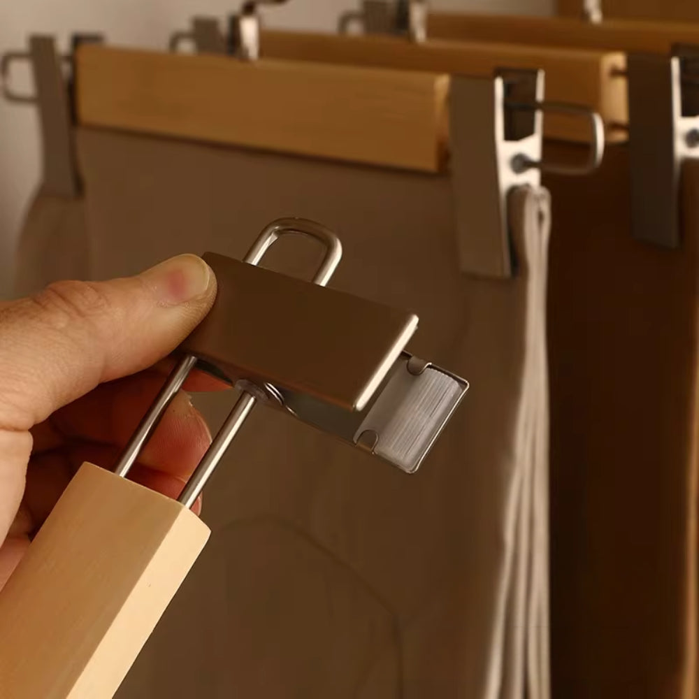 Set of wooden pants hangers with sturdy clips, designed for closet organization. Features a natural wood finish for a classic look, ensuring durability and style. 2