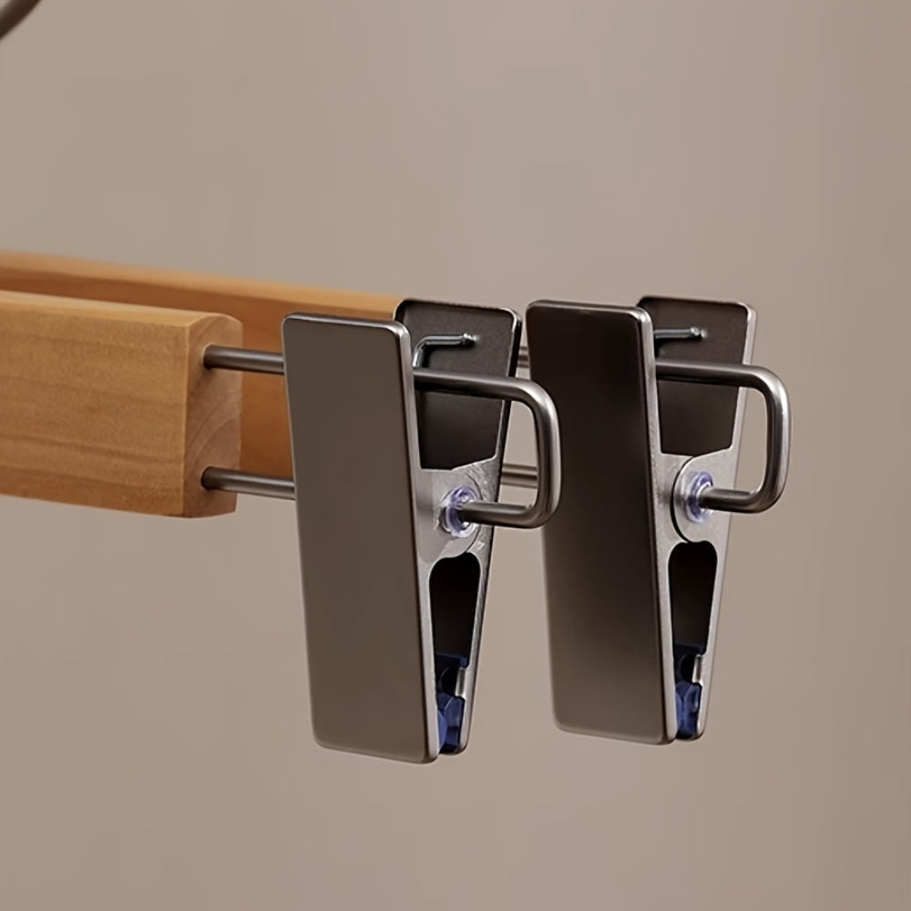 Set of wooden pants hangers with adjustable clips for secure garment holding. Features a sleek natural wood finish, designed for efficient closet organization. Ideal for trousers 4