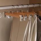Set of wooden pants hangers with adjustable clips, designed for closet organization. Made from durable natural wood with a smooth finish, featuring a sleek design in 5