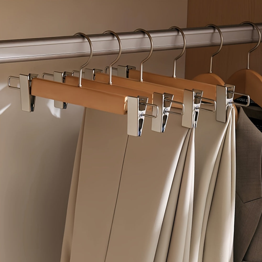 Set of wooden pants hangers with adjustable clips, designed for closet organization. Made from durable natural wood with a smooth finish, featuring a sleek design in 5