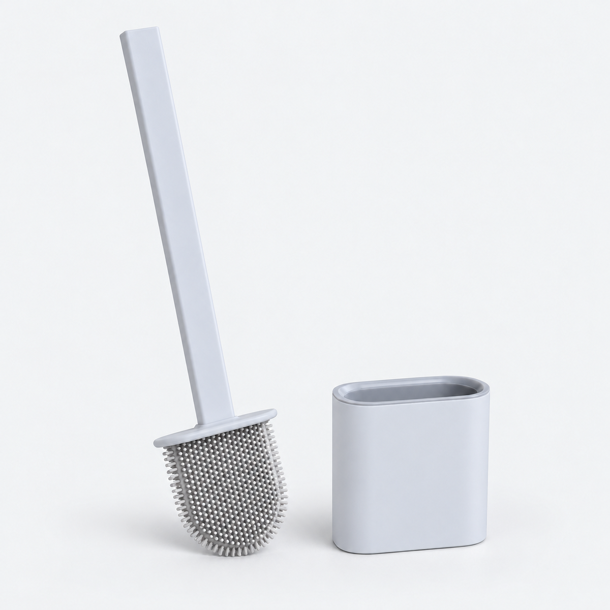 A light gray toilet brush with a long handle and dense bristle head, shown next to its matching rectangular holder on a clean white background.