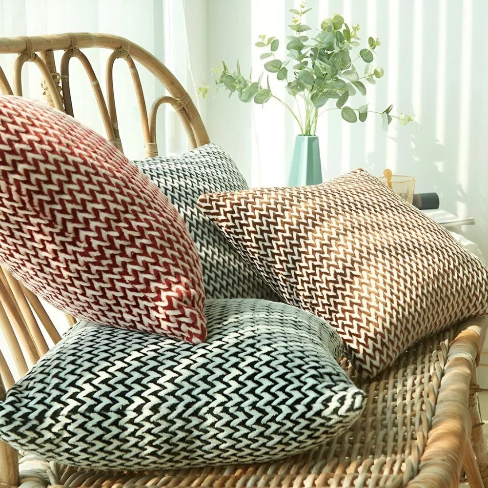 Dear Hazel microfiber cushion covers in red, grey, brown, and black with a chevron pattern and hidden zipper.