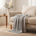 Dear Hazel grey knit throw blanket with fringe, Scandinavian design, soft yarn, perfect for indoor/outdoor comfort.