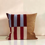 Dear Hazel Mod Blocks striped cushion cover in microfiber blend, featuring red, blue, cream, and gold stripes with an invisible zipper.