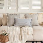 Dear Hazel Scandi-style blue and white striped cotton-linen blend cushion cover with fringed edges.