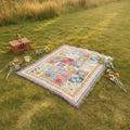 Dear Hazel large microfiber picnic blanket with colorful sun and wave patterns and fringe trim.