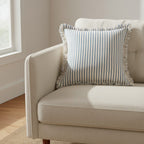 Dear Hazel Scandi-style blue and white striped cotton-linen blend cushion cover with fringed edges.