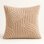 A square throw pillow in a textured beige bouclé fabric with a raised wavy geometric pattern, shown against a plain off-white background.
